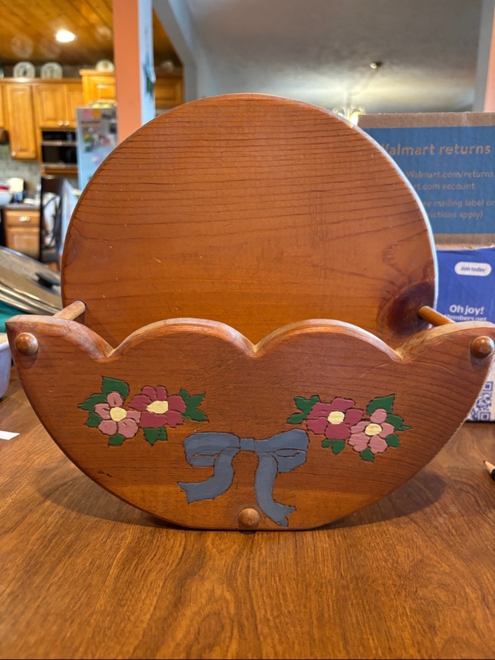 Wooden Paper Plate Holder with Floral and Blue Bow hand painted. Hangs on wall
